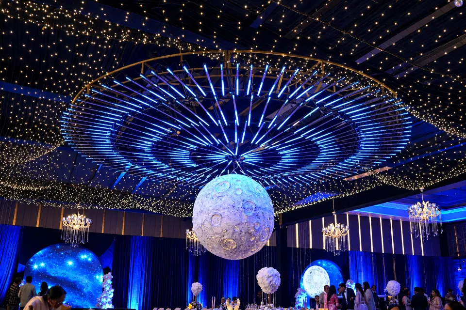 A sangeet dance floor under a glowing moon and a starry ceiling, styled by Bluebird Events